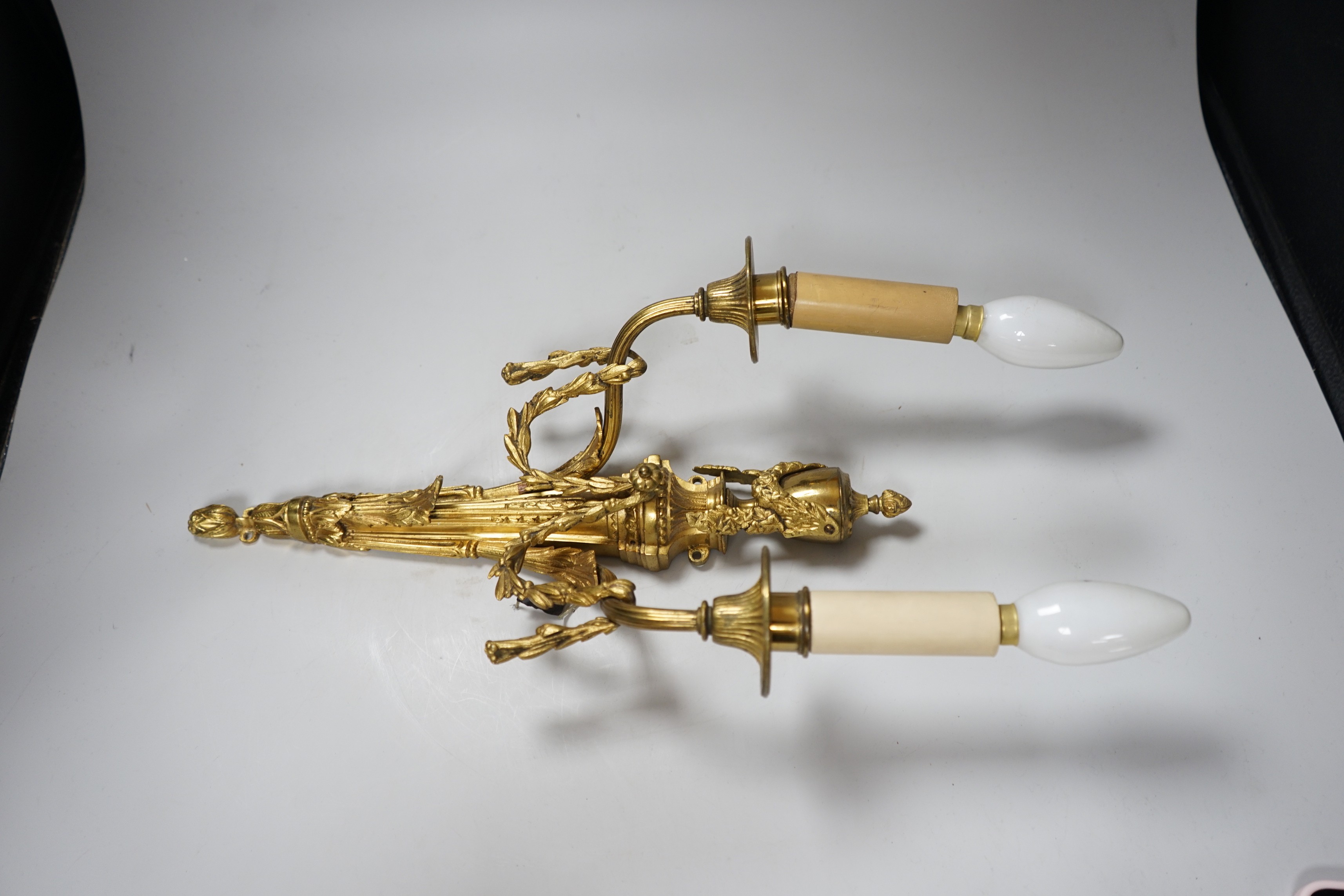 An ornate Louis XVI style gilt metal two branch wall sconce, 48 cm high including bulbs